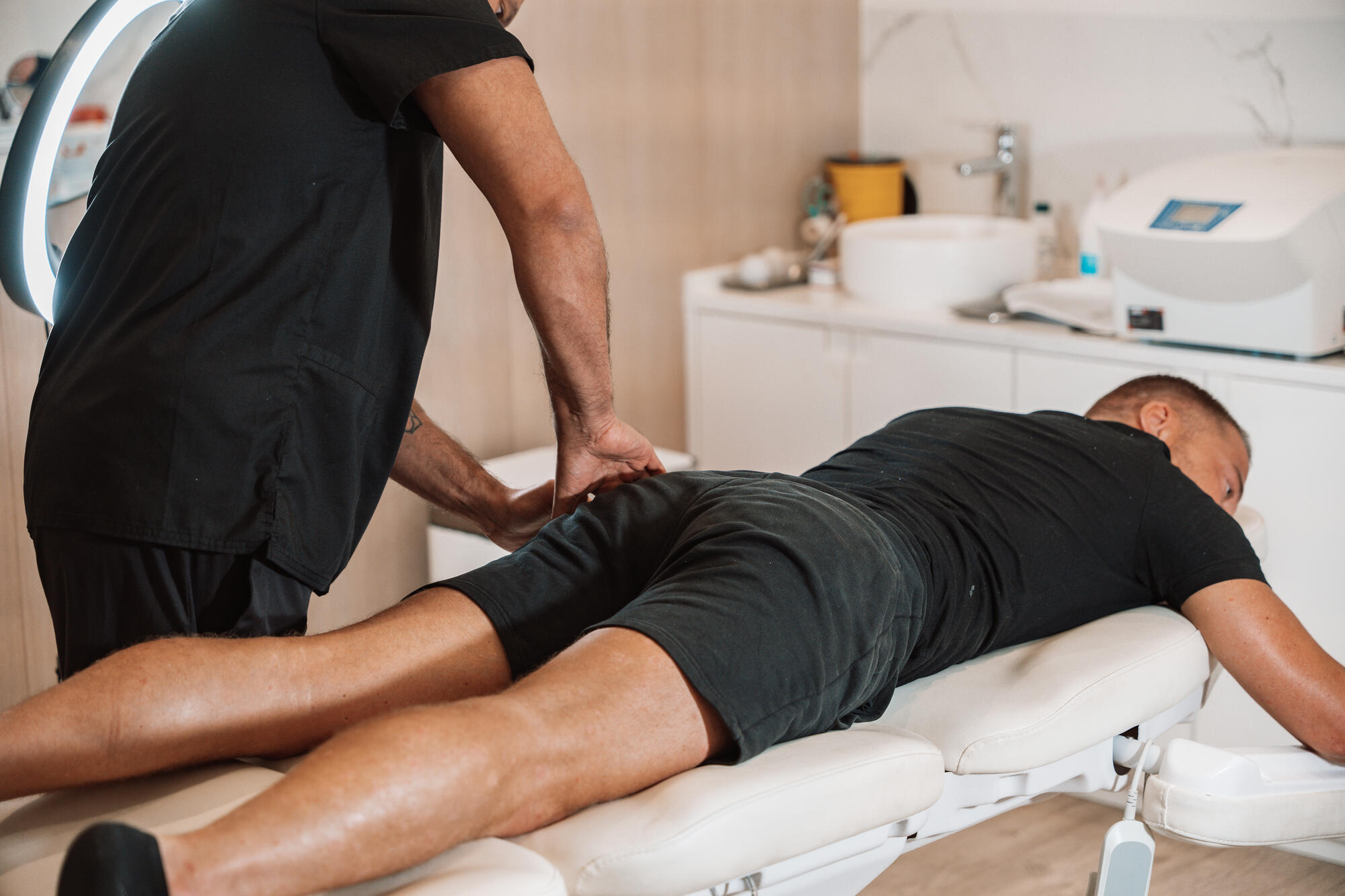 Doctor examining patient's back at CellOrtho Marbella clinic